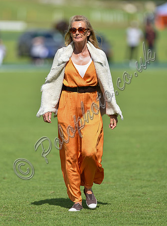 spectators and guests tread in the divots