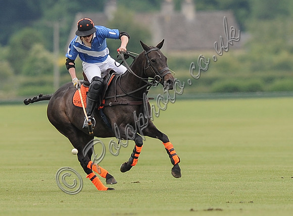 Ollie Severn polo action shot in Lodge Service colours.
