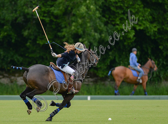 polo action shot of Tabba' Woodd riding left to right