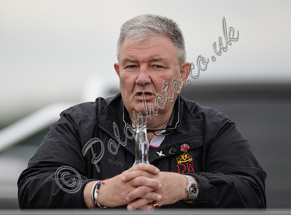 Close-up portrait of Peter Wright wearing a Toggi RAU jacket holding an empty Corona bottle in his hand