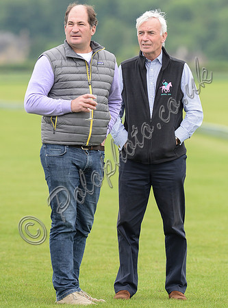 Stirling McGregor wearing grey padded body warmer, wine glass in hand stood with David WSoodd wearing black fleece Zonkey polo body warmer