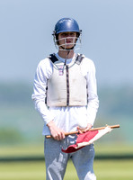 male goal judge waist up holding flag and wearing protective helmet