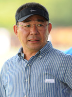 Vichai Raksriaksorn Srivaddhanaprabha wearing polo cap