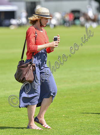 spectators and guests tread in the divots
